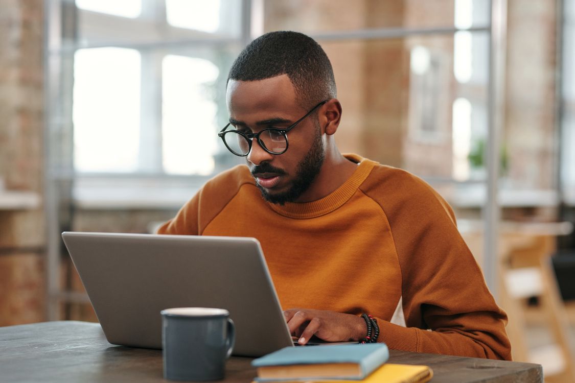 Adult student studying on a laptop at home